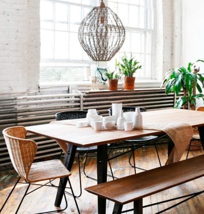 Industrial loft dining room with dining benches and rattan chairs on Thou Swell @thouswellblog