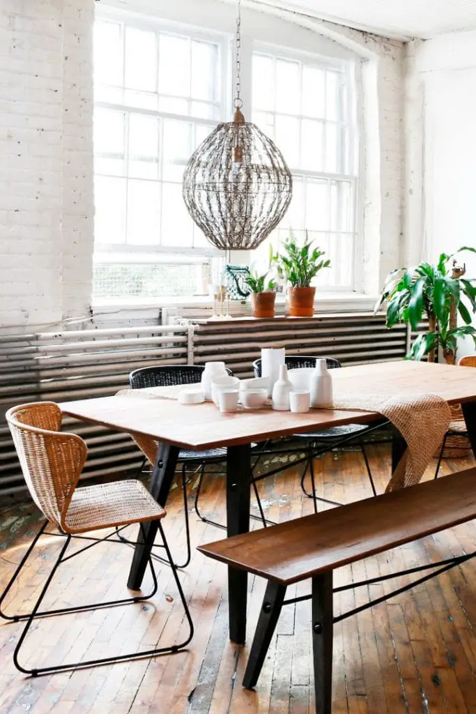 Industrial loft dining room with dining benches and rattan chair on Thou Swell @thouswellblog