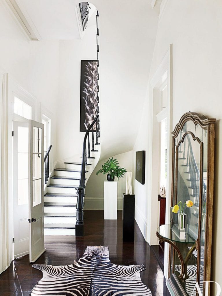 Traditional entryway in New Orleans with gold mirror and zebra rug on Thou Swell @thouswellblog