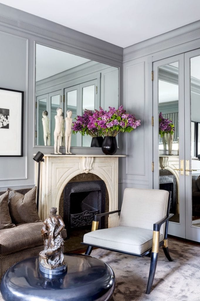 Gorgeous grey mirrored sitting room with marble fireplace and velvet sofa on Thou Swell @thouswellblog