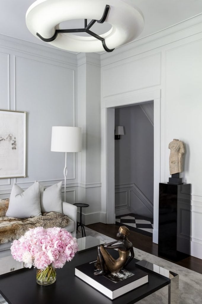 Beautiful contemporary grey living room with statue on black lacquer pedestal via Thou Swell @thouswellblog