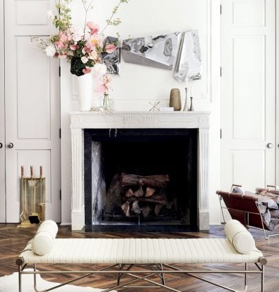 Leather bench with bolster cushions and three-piece mirror set above fireplace mantel in CB2 x goop collection on Thou Swell @thouswellblog