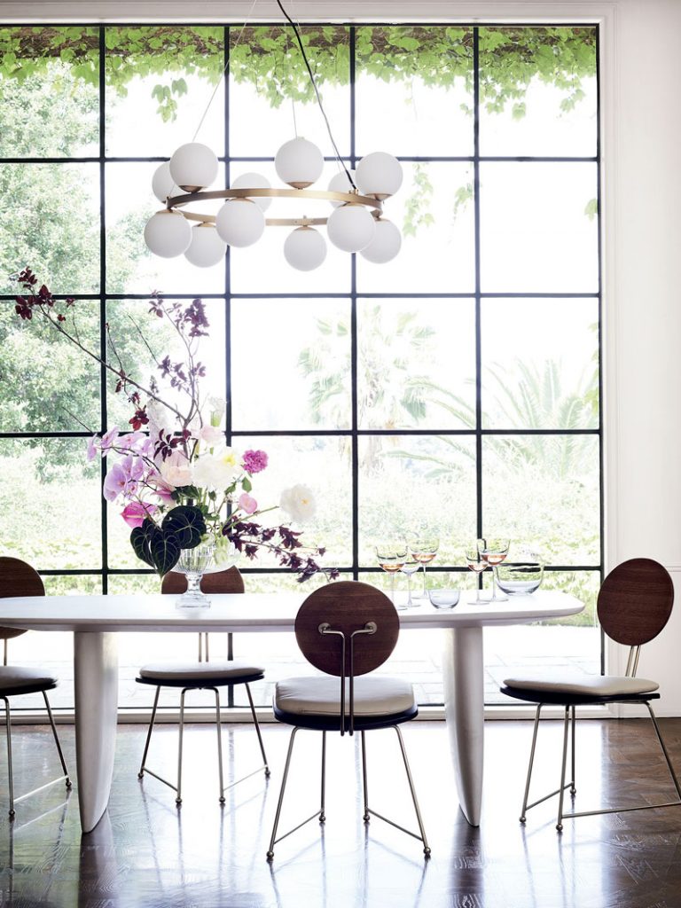 White concrete dining table and modern dining chairs with steel framed window in CB2 x goop collection on Thou Swell @thouswellblog