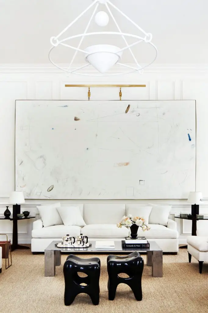 White living room with large painting and sisal rug on Thou Swell @thouswellblog