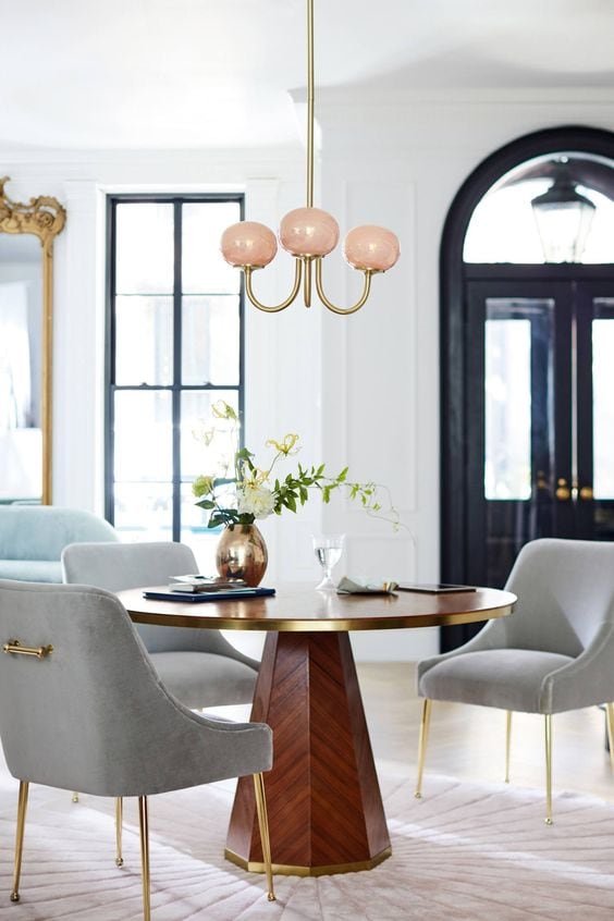 Pedestal table and grey velvet dining chairs with pink LED chandelier on Thou Swell @thouswellblog