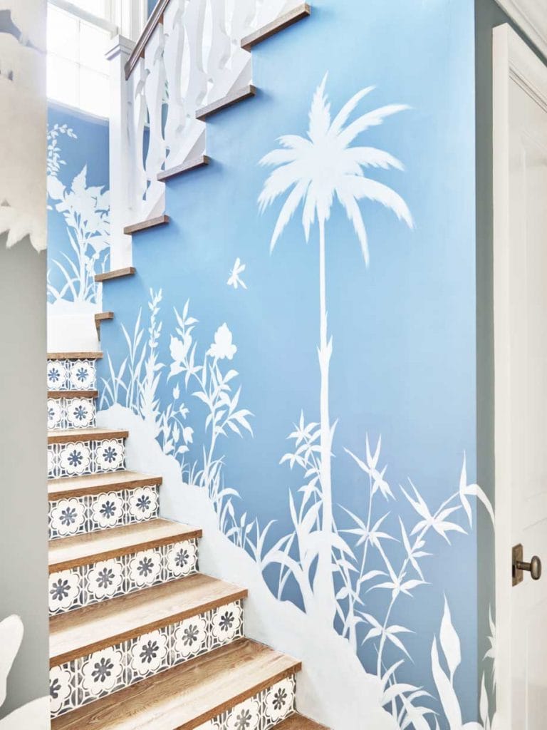 Blue and white staircase with tile risers and palm tree wallpaper in Palm Beach on Thou Swell #hometour #palmbeach #staircase #coastaldecor