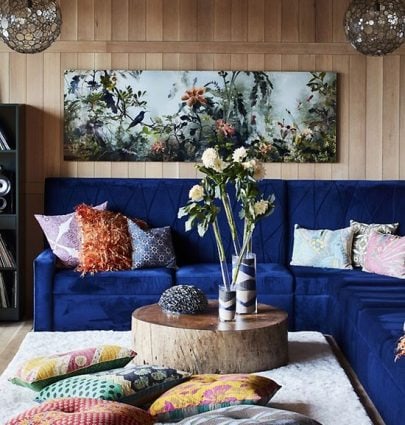 WORLDLY MAXIMALISM AT HOME IN AUSTIN 1 Austin home tour with dark blue velvet sectional and wooden wall paneling on Thou Swell #livingroom #livingroomdesign #austinhome #hometour