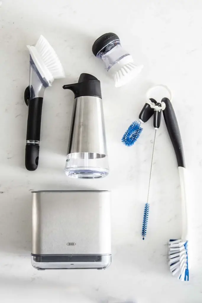 Spring cleaning in a modern kitchen design with @oxo cleaning tools on Thou Swell AD #oxobetter #springcleaning #kitchen #kitchendesign 