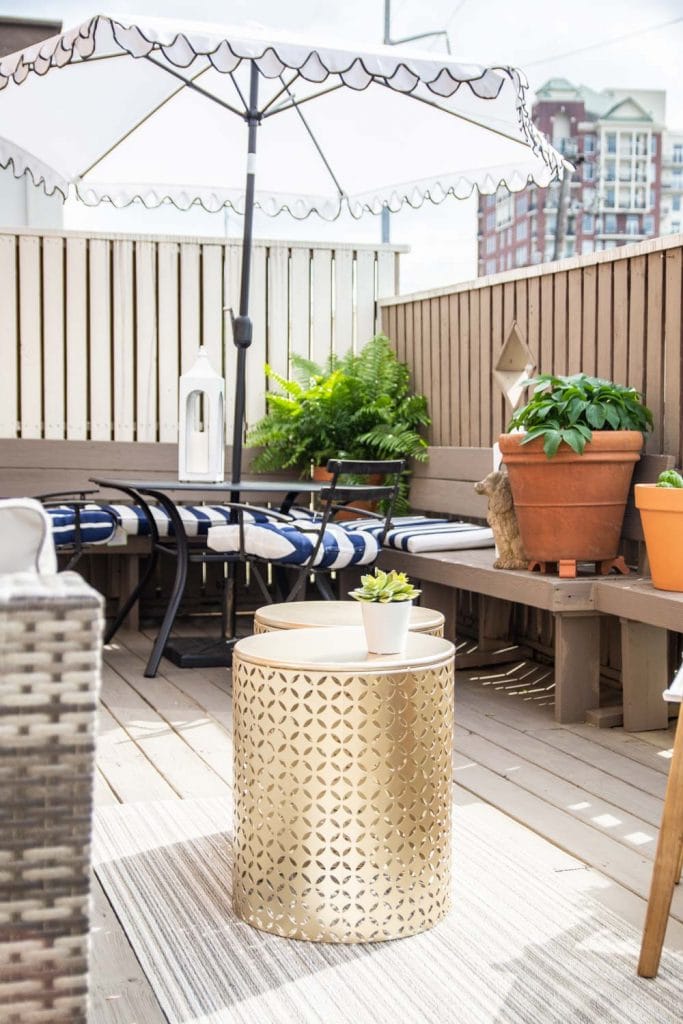 Outdoor deck design with At Home with scalloped umbrella, blue and white stripes, gold tables, and Chilewich mat on Thou Swell #deck #deckdesign #deckdecor #outdoordecor #outdoorfurniture #outdoordesign