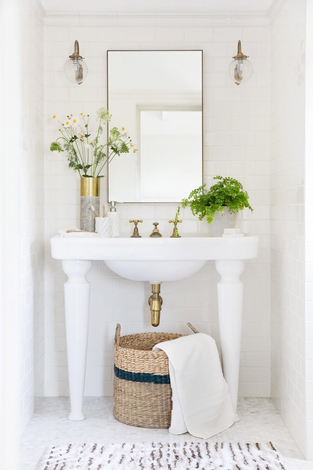 NORDSTROM ANNIVERSARY SALE HOME DECOR FINDS 20 Classic white bathroom with subway tile, fern, glass sconces, and wicker basket storage on Thou Swell @thouswellblog #bathroom #bathroomdesign #classicbathroom #classicdesign #interiordesign