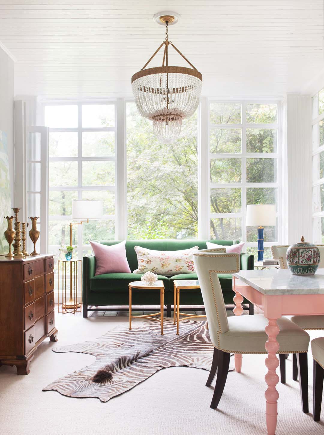 SWELL SHOPPING: PLAYFUL DRUID HILLS FAMILY ROOM 4 Playful Druid Hills family room in Atlanta with green velvet sofa, pink dining table, and zebra hide rug on Thou Swell #familyroom #druidhills #atlantahome #atlantahomes #familyroomdesign #interiordesign #greensofa