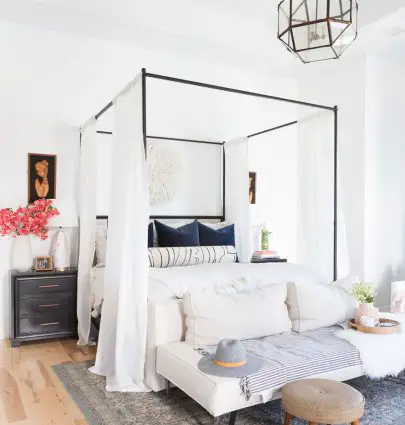 Bright and playful master bedroom design with canopy bed, white curtains, upholstered bench, and grey area rug on Thou Swell @thouswellblog #bedroom #bedroomdesign #masterbedroom #bedroomdecor #jujuhat #interiordesign