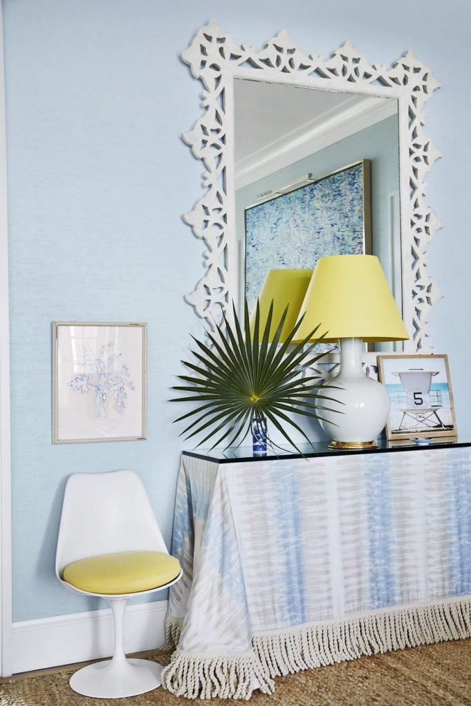 Blue and white vignette with skirted table and yellow accent decor designed by Miles Redd on Thou Swell #skirtedtable #blueandwhite #bluedecor #coastaldecor #coastaldesign #bahamas #beachhouse #milesredd