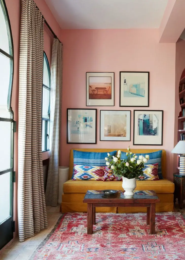 Beautiful pink sitting room with gallery wall in Moroccan house on Thou Swell #morocco #pink #pinkroom #gallerywall #sittingroom #livingroom #interiordesign