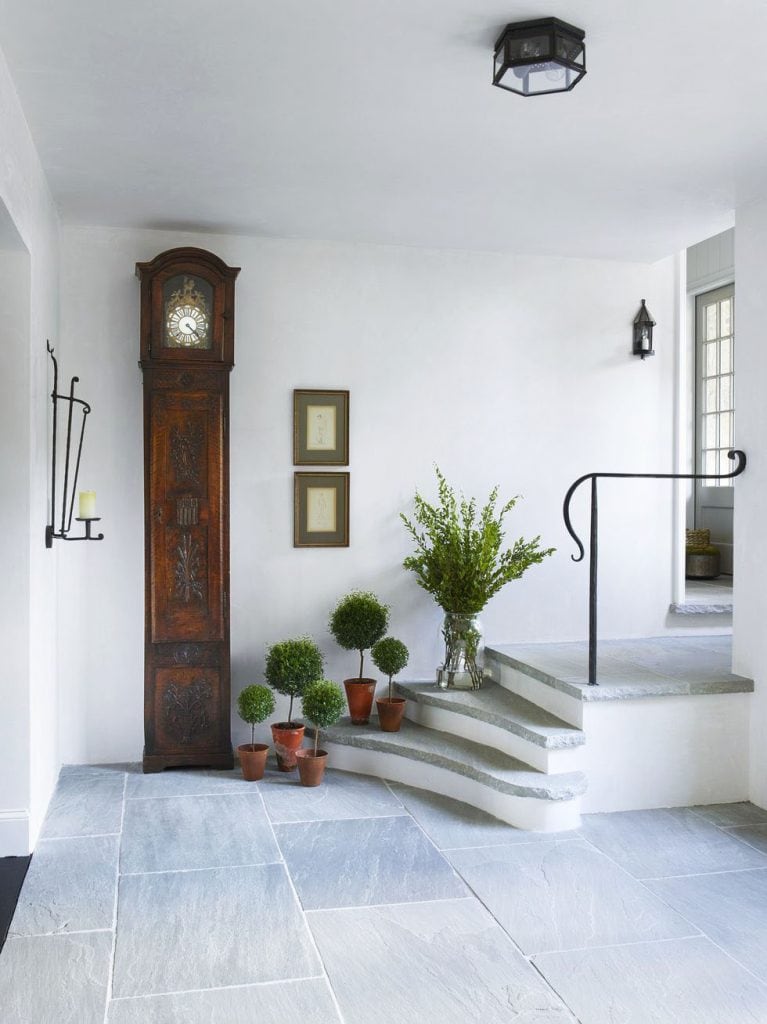 Beautiful back entryway with slate floors and antique clock on Thou Swell in historic Atlanta Tudor house on Thou Swell @thouswellblog #tudor #tudorhouse #renovation #historichouse #historichome #atlantahome #atlantahomes #interiordesign #traditionaldesign #vintagedesign #entry #entryway