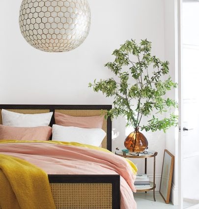FALL STYLE FROM THE SERENA & LILY FAMILY AND FRIENDS EVENT 5 Pink and yellow bedding in modern bedroom with cane wicker bed and capris shell chandelier on Thou Swell #bedroom #bedroomdesign #bedroomstyle #pinkandyellow #homedecor