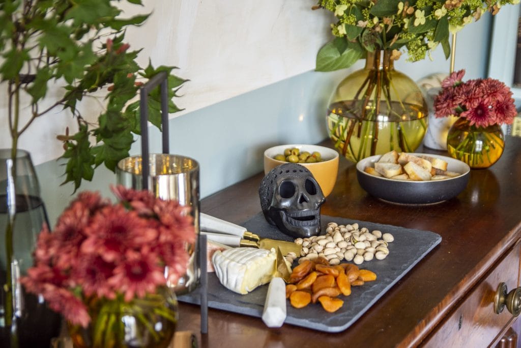 Chic halloween party decor with flowers and cheese board by Kevin O'Gara on Thou Swell #halloween #halloweenparty #halloweendecor #halloweenflowers #cheeseboard #cheese #flowers #partydecor #party #decor #decorideas