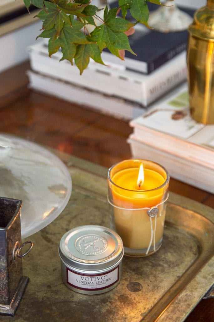 Votivo Venetian Leather fall scented candle on desk in the living room by Kevin O'Gara Thou Swell #fall #falldecor #fallhomedecor #homedecor #falldecor #decorideas #homedecorideas #hygge #hyggedecor #candle #scentedcandle #fallcandle