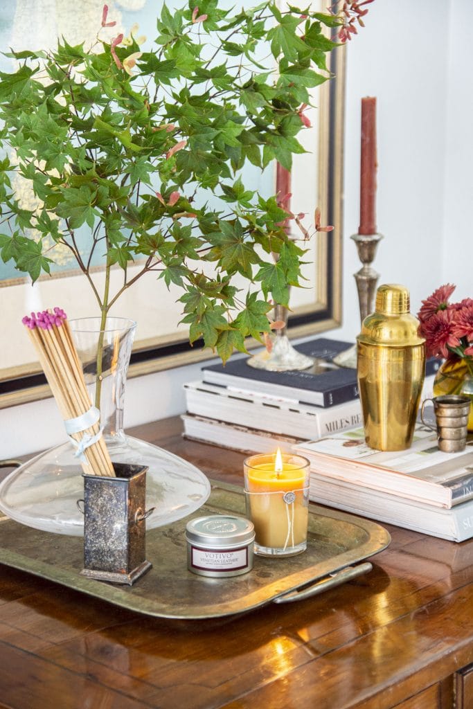 Votivo Venetian Leather fall scented candle on desk in the living room by Kevin O'Gara Thou Swell #fall #falldecor #fallhomedecor #homedecor #falldecor #decorideas #homedecorideas #hygge #hyggedecor #candle #scentedcandle #fallcandle