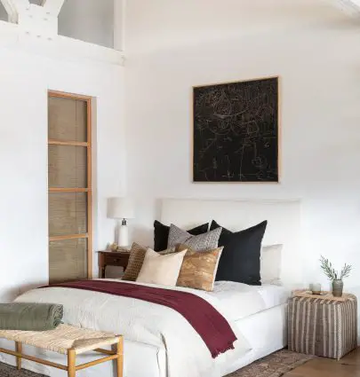 California bedroom design with black painting above bed and vintage kilim textiles and pouf designed by Amber Interiors on Thou Swell #bedroom #bedroomdesign #bedroomdecor #homedecor #homedecorideas #interiordesign