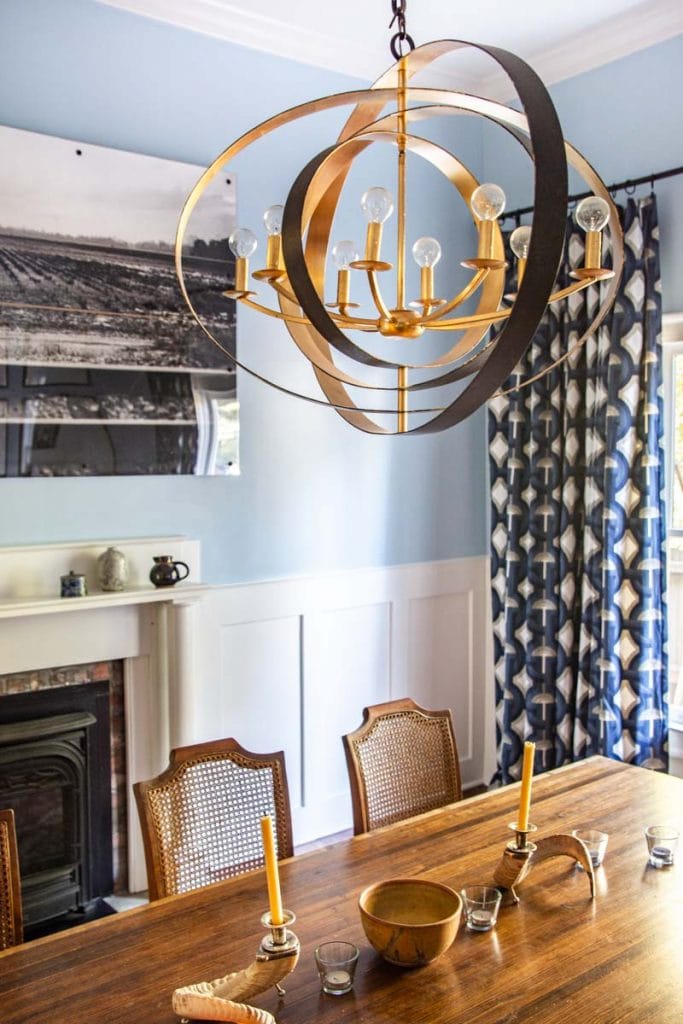 Light blue dining room (Behr Rain Dance) with white flat panel wainscoting (Behr Sleek White) before and after makeover by Kevin O'Gara on Thou Swell #diningroom #diningroomdesign #diningroommakeover #beforeandafter #diypaneling #diymoulding #bluepaint #painting #wainscoting