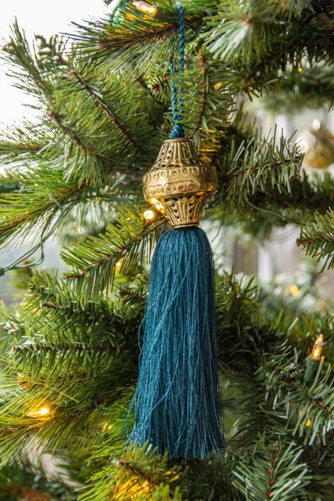 Jewel-tone Christmas tree holiday decor with tassels and boho style from SmithHönig in apartment living room by Kevin O'Gara on Thou Swell #christmas #christmastree #christmasdecor #holidaydecor #bohodecor #bohochristmas #tassels #smithhonig #apartment #apartmentdecor #livingroomdesign