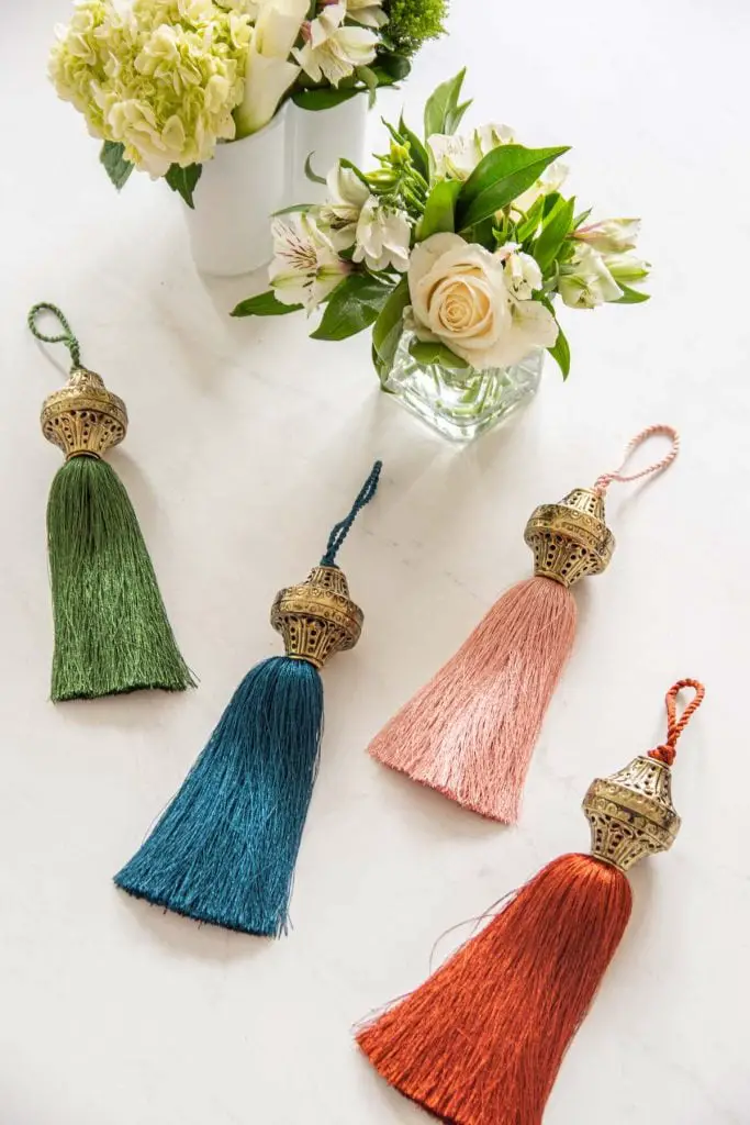 Jewel-tone Christmas tree holiday decor with tassels and boho style from SmithHönig in apartment living room by Kevin O'Gara on Thou Swell #christmas #christmastree #christmasdecor #holidaydecor #bohodecor #bohochristmas #tassels #smithhonig #apartment #apartmentdecor #livingroomdesign