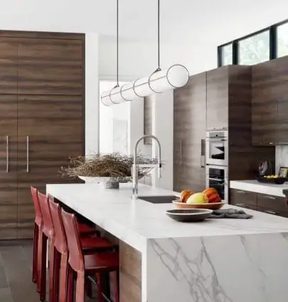 Minimalist kitchen design with red counter stools and marble waterfall island in modern Dallas home tour on Thou Swell #dallas #dallashome #hometour #homedesign #interiordesign #moderndesign #minimalist #minimaldesign #kitchen #kitchendesign #modernkitchen #modernkitchendesign #moderndesign