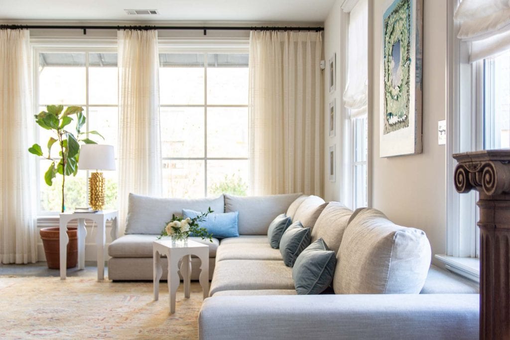 Artlce Gaba sofa modular sectional sofa design in apartment living room with big windows, vintage Turkish rug, and blue velvet pillows by Kevin O'Gara on Thou Swell #article #gabasofa #livingroom #livingroomdesign #apartment #apartmentdesign #homedesign #homedecor #interiordesign