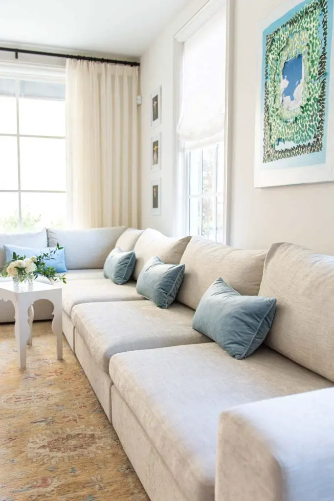 Artlce Gaba sofa modular sectional sofa design in apartment living room with big windows, vintage Turkish rug, and blue velvet pillows by Kevin O'Gara on Thou Swell #article #gabasofa #livingroom #livingroomdesign #apartment #apartmentdesign #homedesign #homedecor #interiordesign