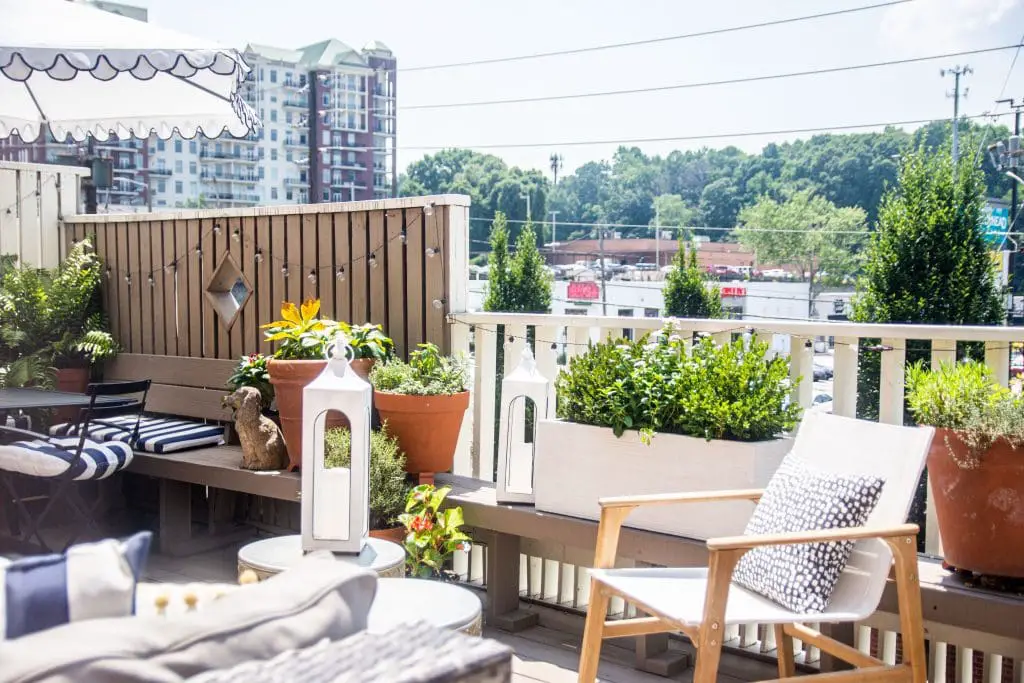 Patio deck design with potted plants and outdoor furniture in Buckhead Atlanta townhouse on Thou Swell #patio #deck #outdoordeck #deckfurniture #deckdesign #buckhead #buckheadatlanta #townhouse #outdoordesign