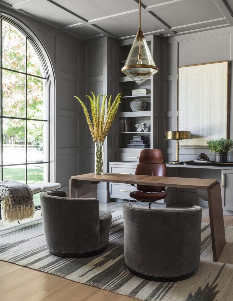 Grey home office design with arched window and barrel chairs on Thou Swell #office #homeoffice #officedesign #greyoffice #greyroom #greywalls #greypaint #homedecor #homedesign #interiordesign