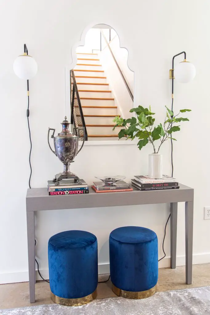 Modern entryway design with AllModern grey console table, blue velvet stools, and sconce lights on Thou Swell #entry #entryway #entrywaydesign #entrywaydecor #entrydesign #allmodern