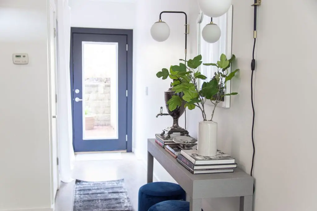 Modern entryway decor with AllModern grey console table, blue velvet stools, and sconce lights on Thou Swell #entry #entryway #entrywaydesign #entrywaydecor #entrydesign #allmodern