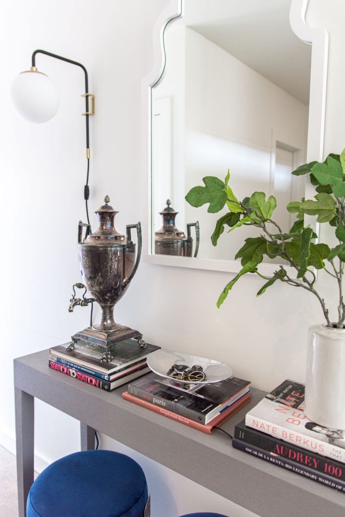 Modern entryway decor with AllModern grey console table, blue velvet stools, and sconce lights on Thou Swell #entry #entryway #entrywaydesign #entrywaydecor #entrydesign #allmodern