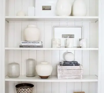 Suzanne Kasler Interiors white shelf styling home decor accessories by Kevin O'Gara Photography interior photographer in Atlanta