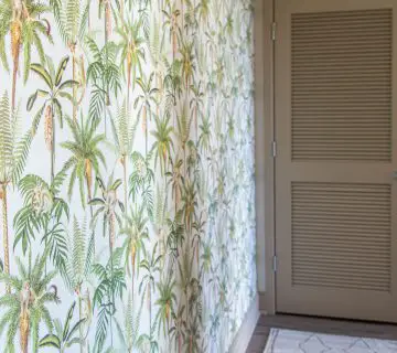 Tropical leaf and monkey wallpaper by Walls Republic in an apartment entryway accent wall on Thou Swell #homedecor #homedecorideas #wallpaper #tropicalwallpaper #monkeys #accentwall #wallsrepublic