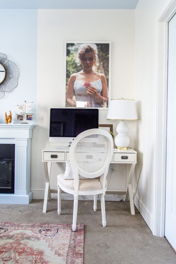 Behr Swiss Coffee, a popular warm white paint color for walls in a blue and white bedroom by Kevin O'Gara #swisscoffee #behrpaint #whitepaint #paintingideas #paintcolors #bedroomdesign #warmwhite #homedecorideas #interiordesign