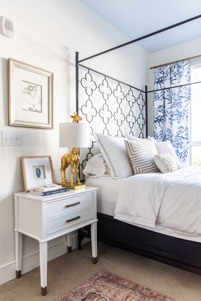 Behr Swiss Coffee, a best off-white paint color for walls in a blue and white bedroom by Kevin O'Gara #swisscoffee #behrpaint #whitepaint #paintingideas #paintcolors #bedroomdesign #warmwhite #homedecorideas #interiordesign