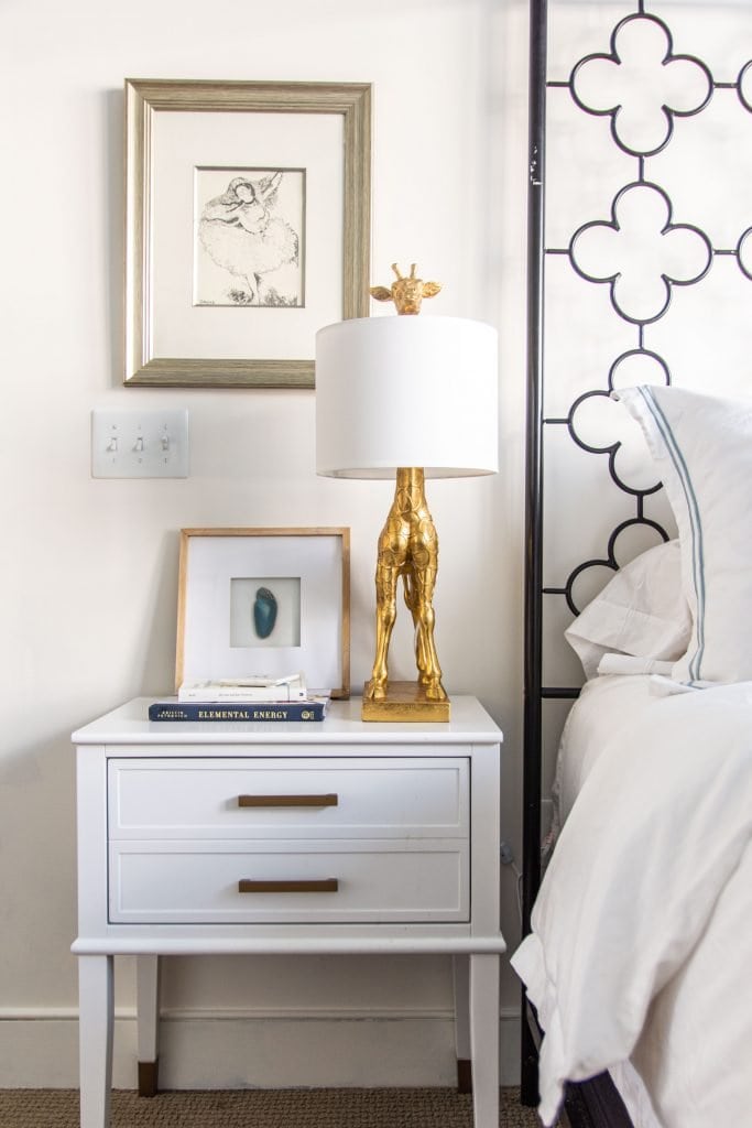 Behr Swiss Coffee, a popular warm white paint color for walls in a blue and white bedroom by Kevin O'Gara #swisscoffee #behrpaint #whitepaint #paintingideas #paintcolors #bedroomdesign #warmwhite #homedecorideas #interiordesign