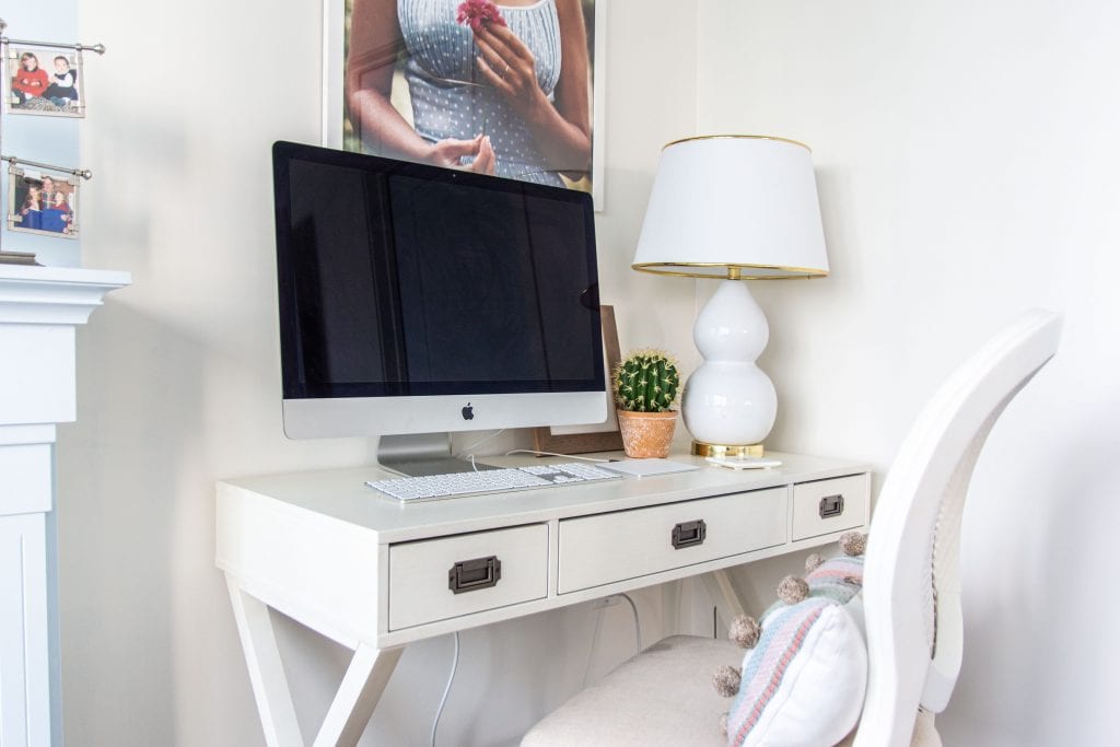 Behr Swiss Coffee, a popular warm white paint color for walls in a blue and white bedroom by Kevin O'Gara #swisscoffee #behrpaint #whitepaint #paintingideas #paintcolors #bedroomdesign #warmwhite #homedecorideas #interiordesign