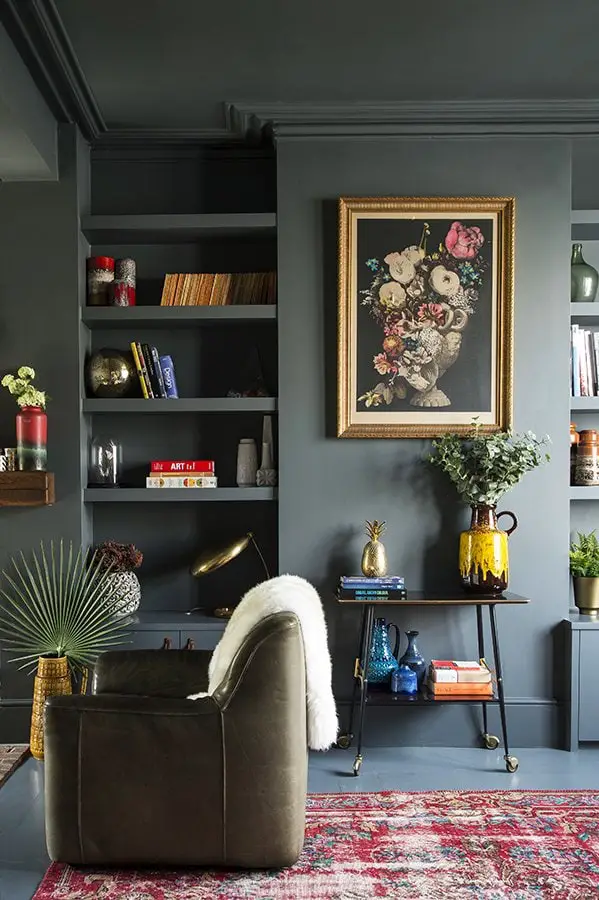 Dark green living room walls with pops of color, eclectic home decor, living room design on Thou Swell #livingroom #livingroomdesign #livingroomdecor #greenlivingroom #darkgreen #darkgreenwalls #greenwalls 