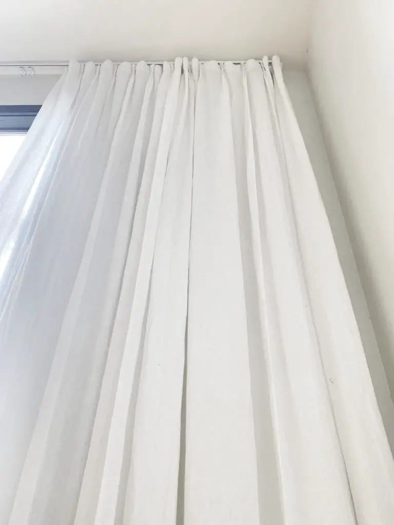 Custom tall sheer white linen curtains for double-story living room window on Thou Swell #curtains #drapery #linen #livingroom #livingroomdesign #livingroomdecor #homedecorideas