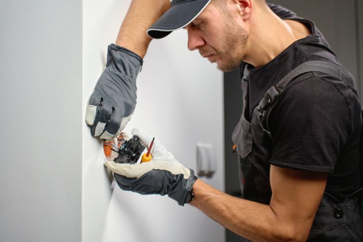 The Invisible Artistry: Why Electrical Sophistication is the Foundation of Refined Interior Design 2 Electrician working